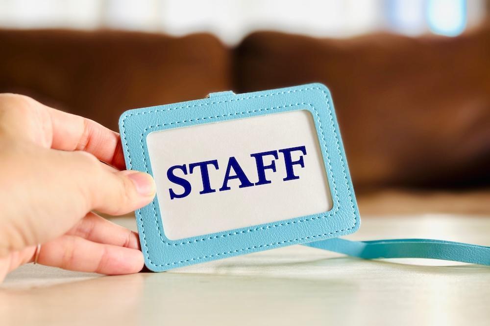 Hand holding a staff name badge